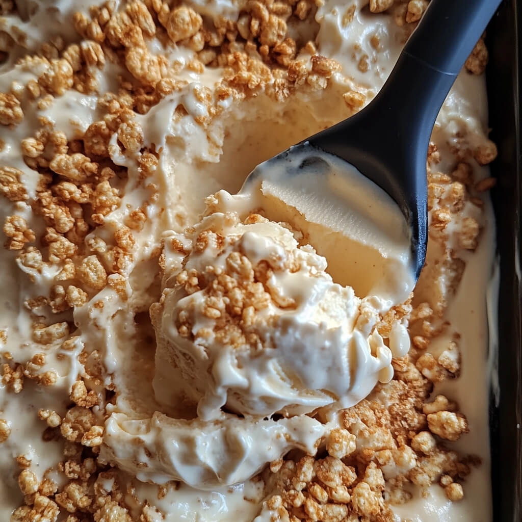 spreading-ice-cream-layer spreading vanilla ice cream over rice krispie base