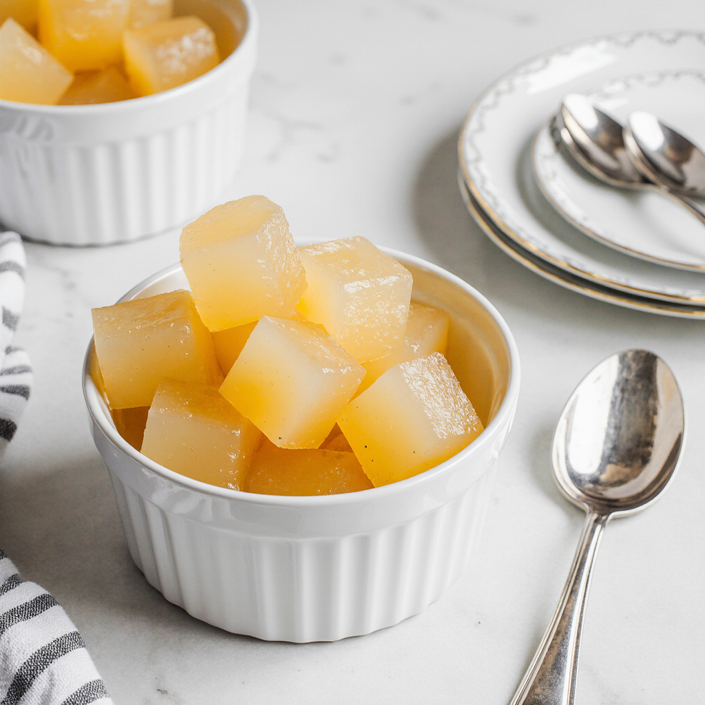 Berry or coffee flavored gelatin cubes styled on rustic wood with cozy light